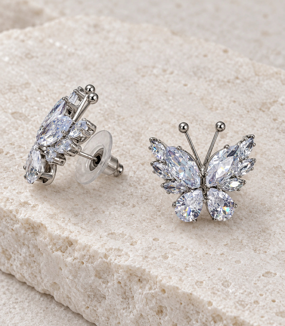 JIMIKI Marquise Teardrop Butterfly Stud Earring Pair in Silver tone/Clear, editorial flat lay #color_silver tone/clear