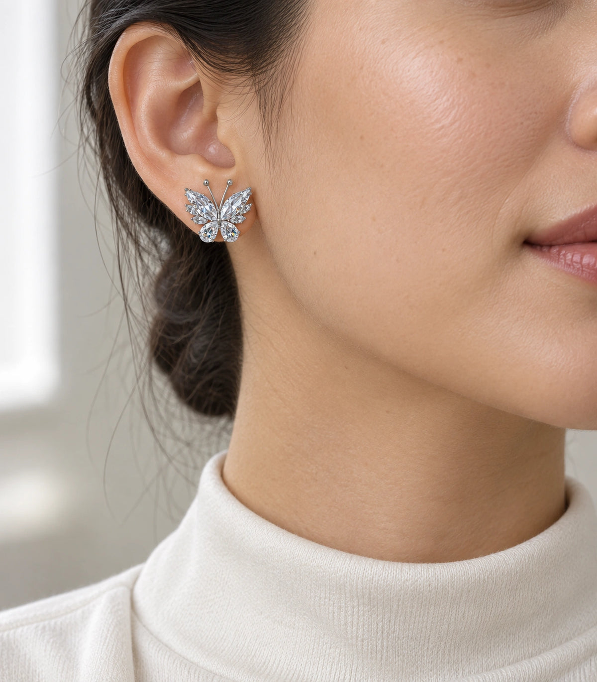 JIMIKI Marquise Teardrop Butterfly Stud Earring Pair in Silver tone/Clear, model wearing view #color_silver tone/clear
