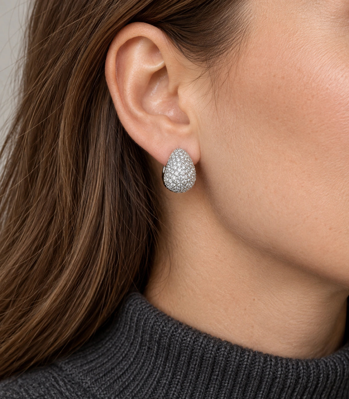 JIMIKI Silver Tone Clear Pave Domed Teardrop Stud Earring Pair in Silver tone/Clear, model wearing view