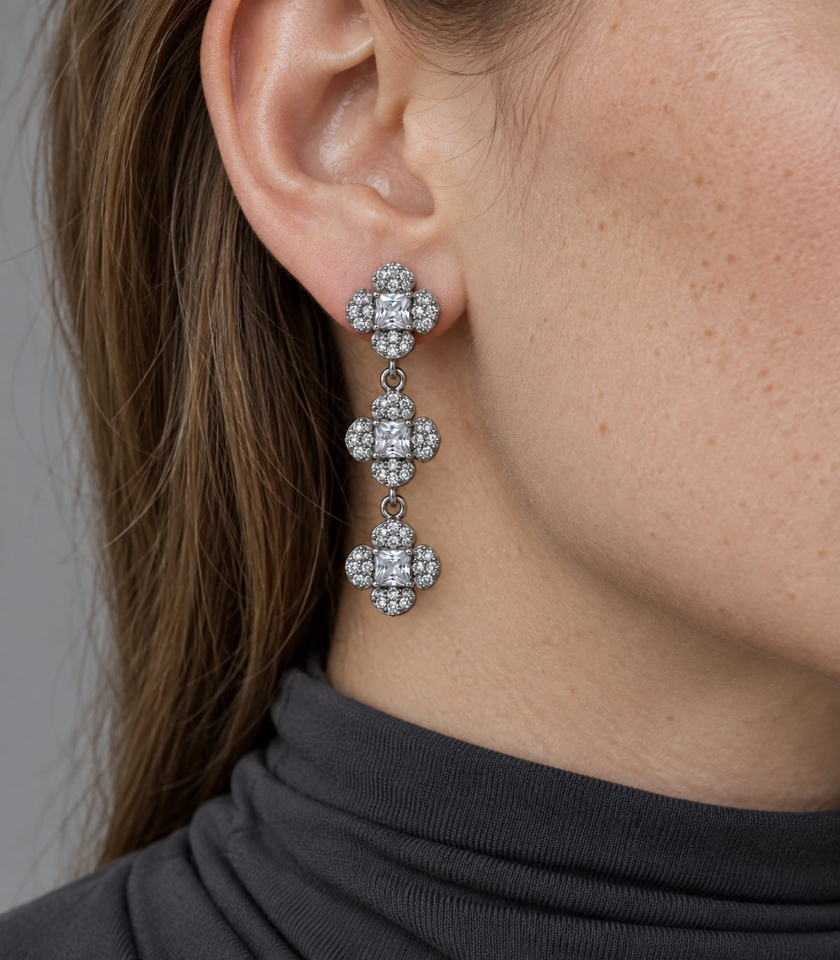 JIMIKI Triple Four Petal Flower Drop Earring Pair in Silver tone / clear, close-up detail #color_silver tone / clear