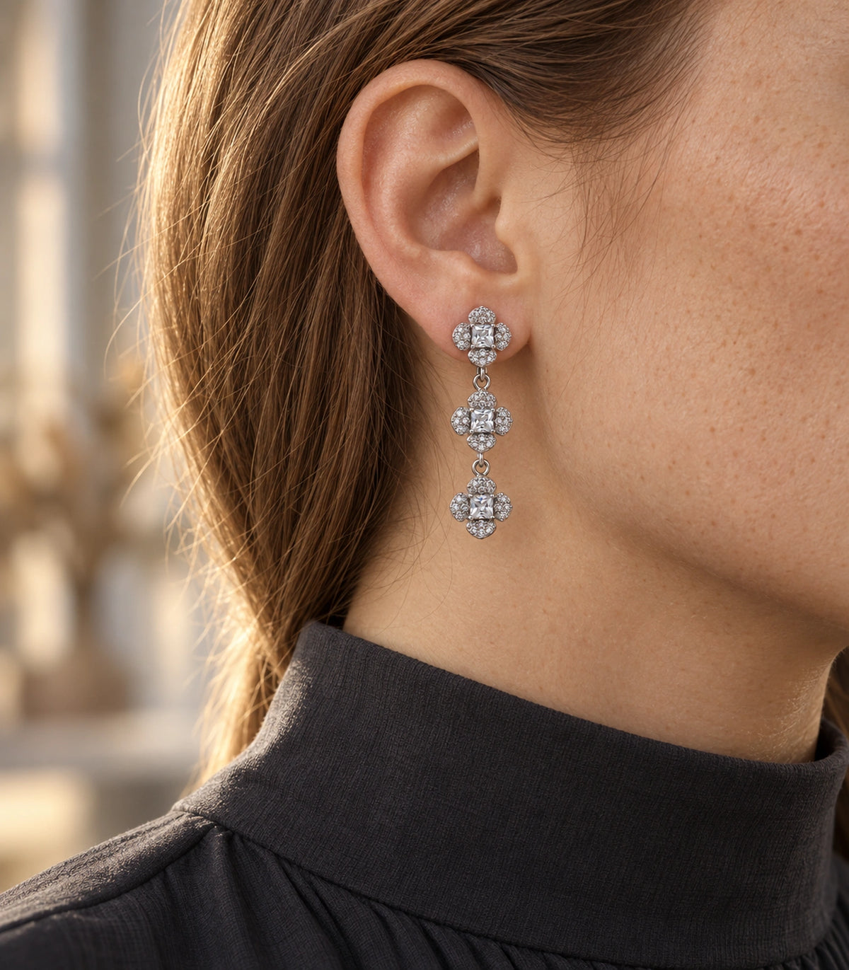 JIMIKI Triple Four Petal Flower Drop Earring Pair in Silver tone / clear, editorial model view #color_silver tone / clear