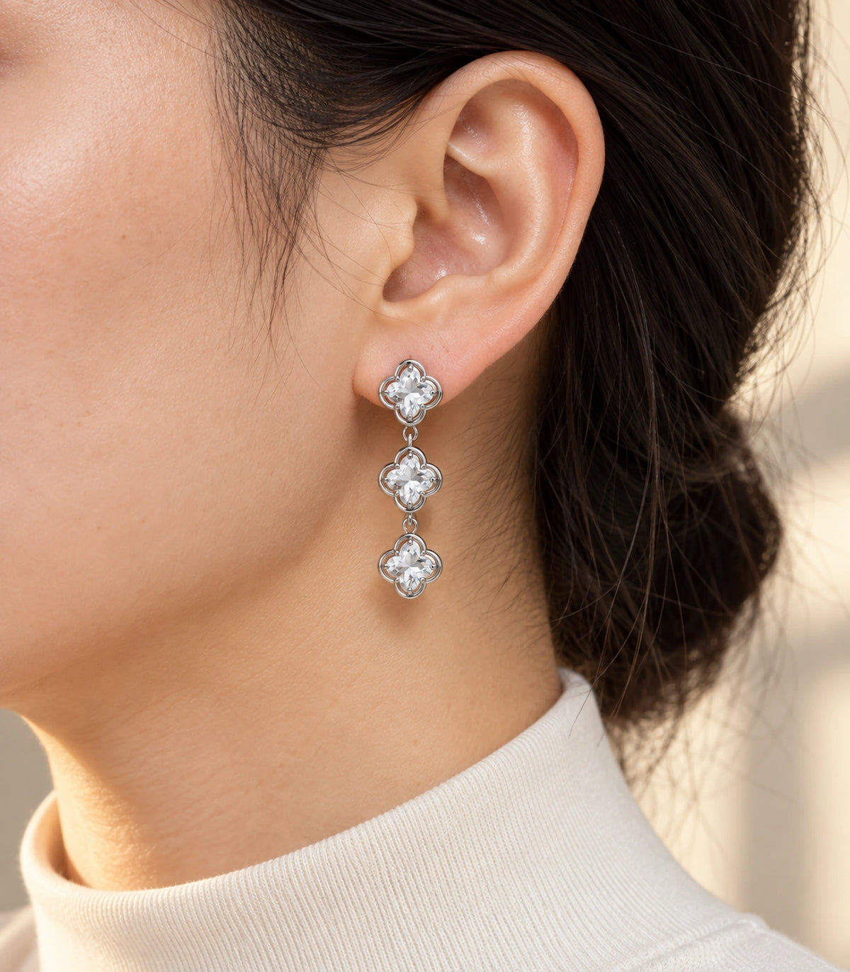 JIMIKI Triple Quatrefoil Crystal Drop Earring Pair in Silver tone / clear, editorial model view #color_silver tone / clear