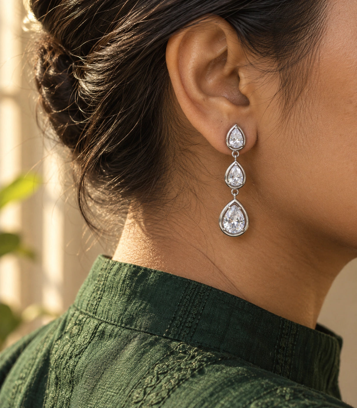 JIMIKI Silver Tone Clear Triple Teardrop Drop Earring Pair in Silver Tone, editorial model view
