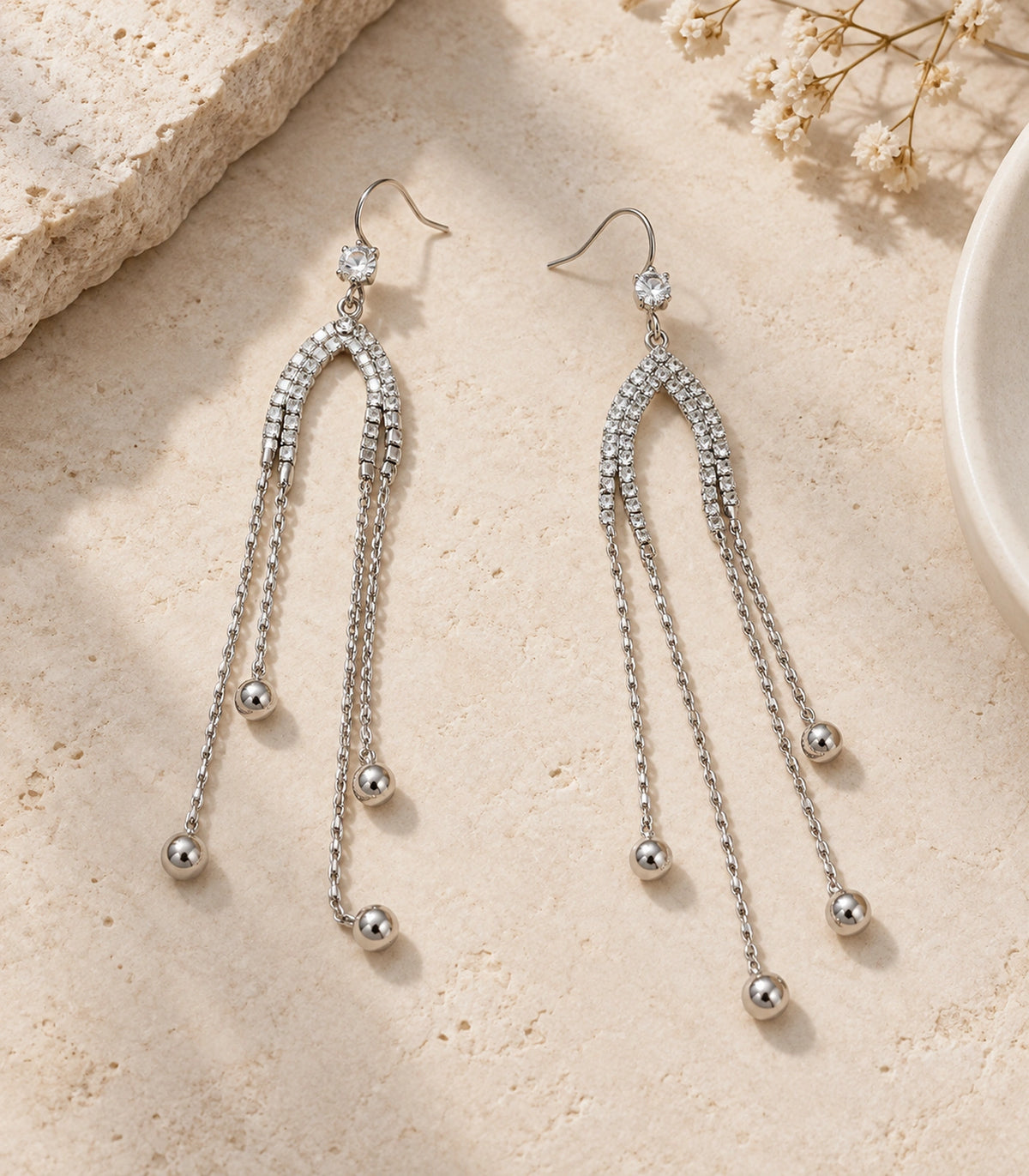 JIMIKI Silver Tone Crystal Arch Four Ball Chain Earring Pair in Silver-tone, editorial flat lay