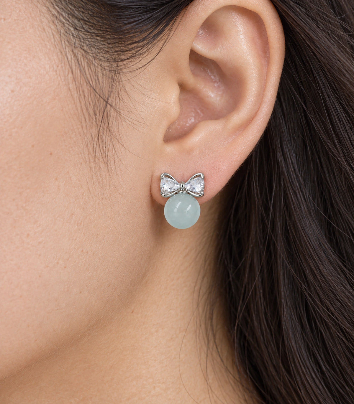 JIMIKI Silver-Tone Crystal Bow Blue Bead Stud Earrings in Silver-tone / pale blue, close-up detail