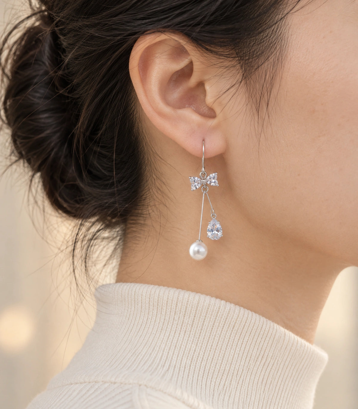 JIMIKI Silver Tone Crystal Bow Pear Pearl Wire Drop Earring Pair in Silver-tone, editorial model view