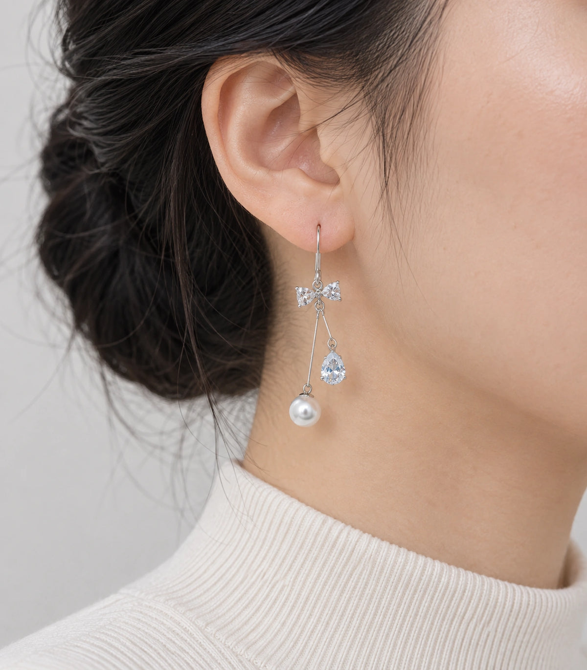 JIMIKI Silver Tone Crystal Bow Pear Pearl Wire Drop Earring Pair in Silver-tone, model wearing view