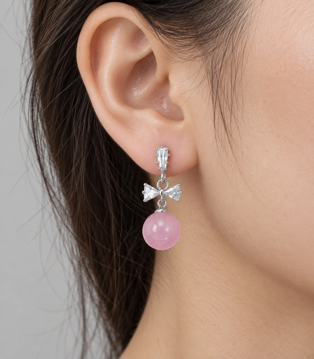 JIMIKI Silver-Tone Crystal Bow Pink Bead Drop Earrings in Silver / Clear / Pink, close-up detail