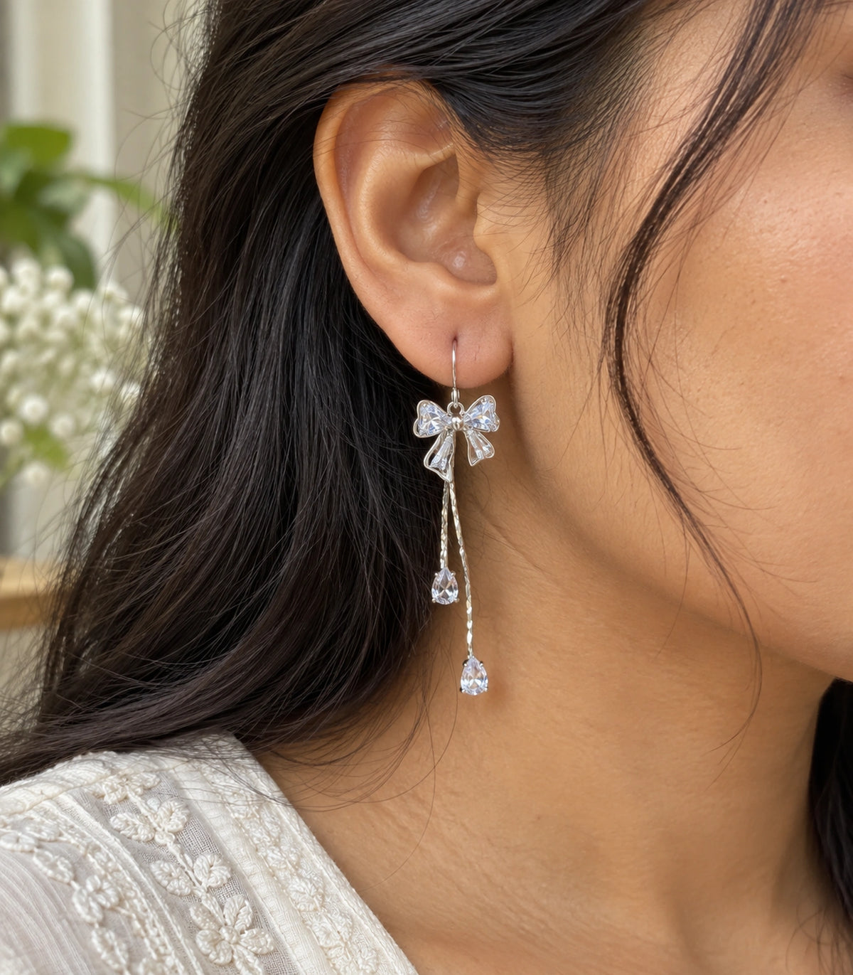 JIMIKI Silver-Tone Crystal Bow Twin Pear Drop Earrings in Silver Tone, close-up detail