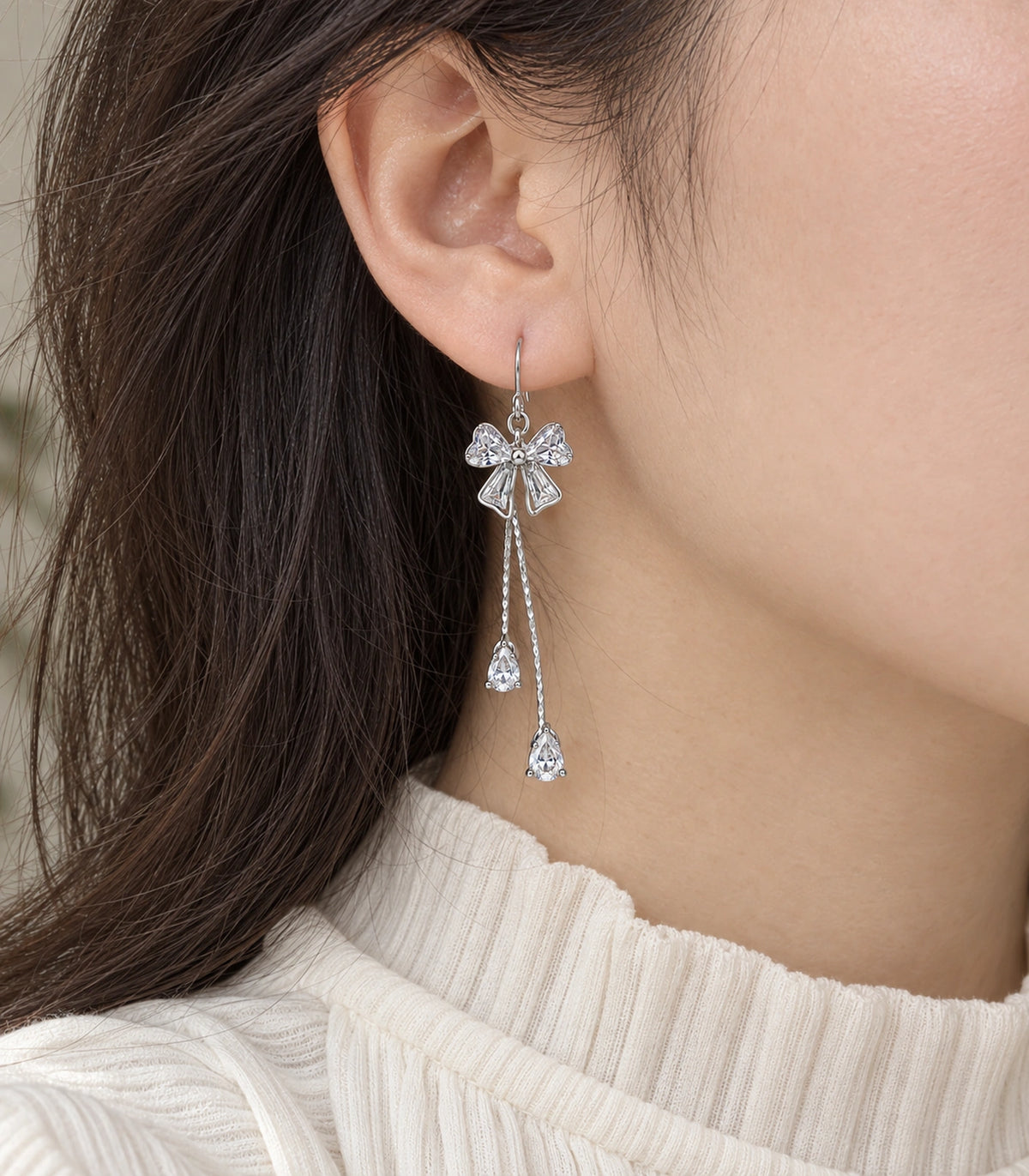 JIMIKI Silver-Tone Crystal Bow Twin Pear Drop Earrings in Silver Tone, model wearing view