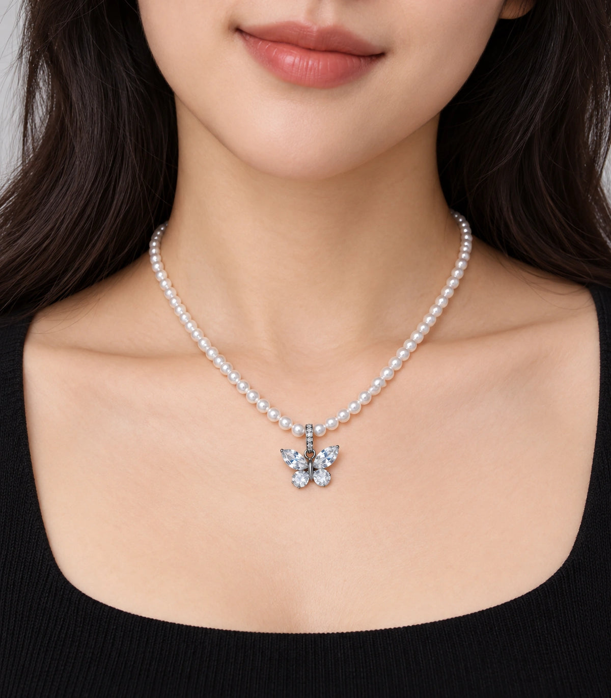 JIMIKI Silver-Tone Crystal Butterfly Pearl Necklace in Silver-tone / clear / white, worn with a simple outfit