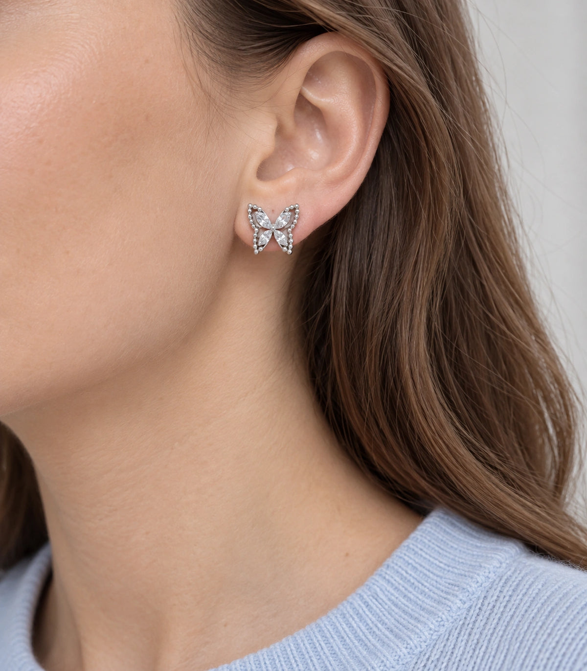 JIMIKI Silver-Tone Crystal Butterfly Stud Earrings in Silver / Clear, model wearing view
