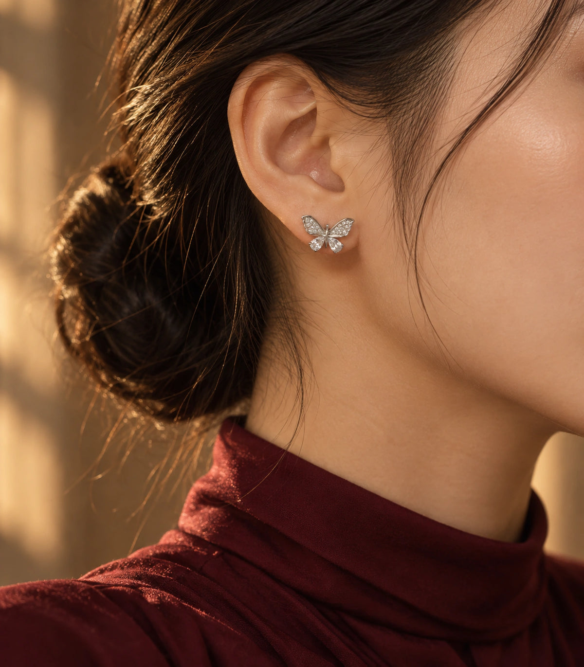 JIMIKI Silver-Tone Crystal Butterfly Stud Earrings in Silver / Clear, editorial model view