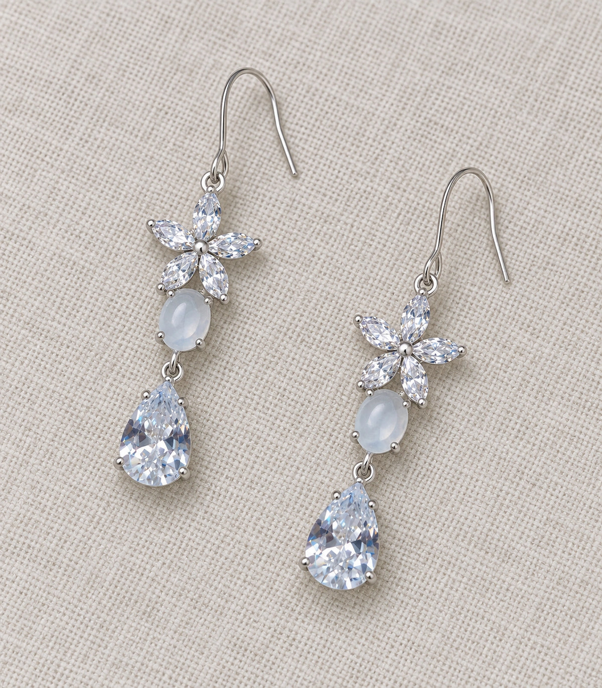 JIMIKI Silver Tone Crystal Flower White Bead Pear Drop Earring Pair in Silver tone, editorial flat lay
