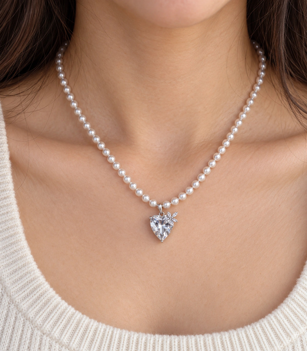 JIMIKI Silver-Tone Crystal Heart Pearl Necklace in Silver-tone / clear / white, close-up of the pendant and pearl-style strand
