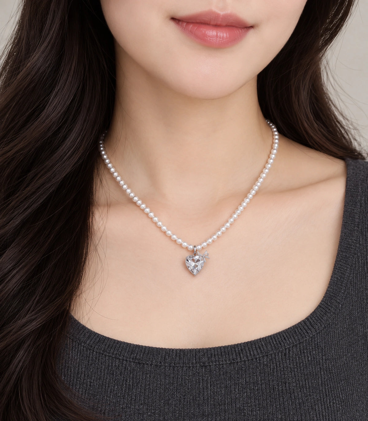 JIMIKI Silver-Tone Crystal Heart Pearl Necklace in Silver-tone / clear / white, worn with a simple outfit