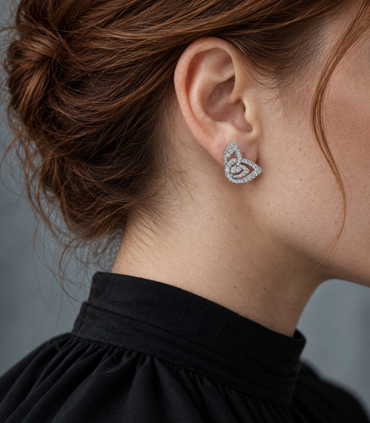 JIMIKI Crystal Open Swirl Stud Earring Pair in Silver tone, editorial model view #color_silver tone