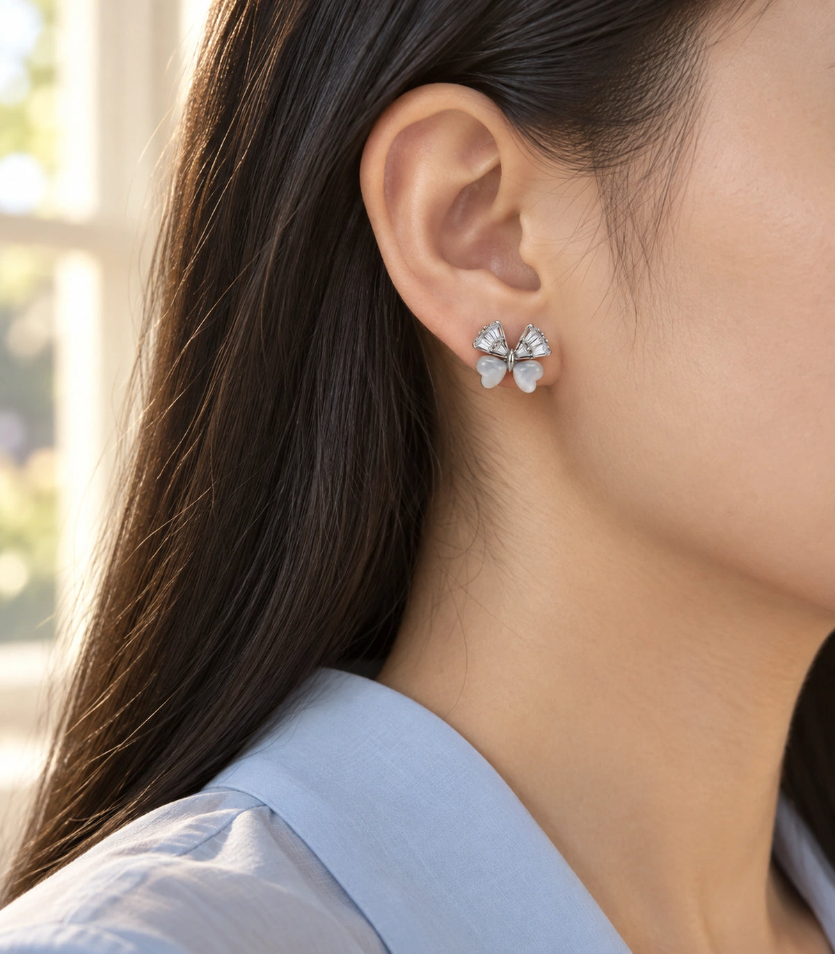 JIMIKI Crystal Wing Butterfly Stud Earring Pair in Silver Tone, editorial model view #color_silver tone