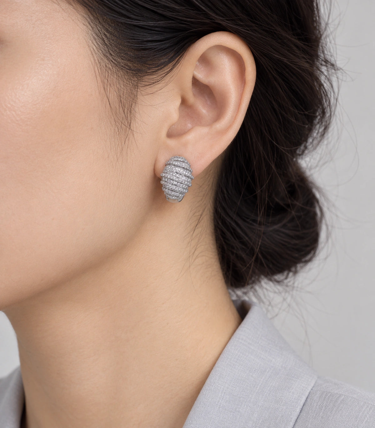 JIMIKI Crystal Ribbed Dome Huggie Earrings in Silver / Clear, model wearing view #color_silver / clear