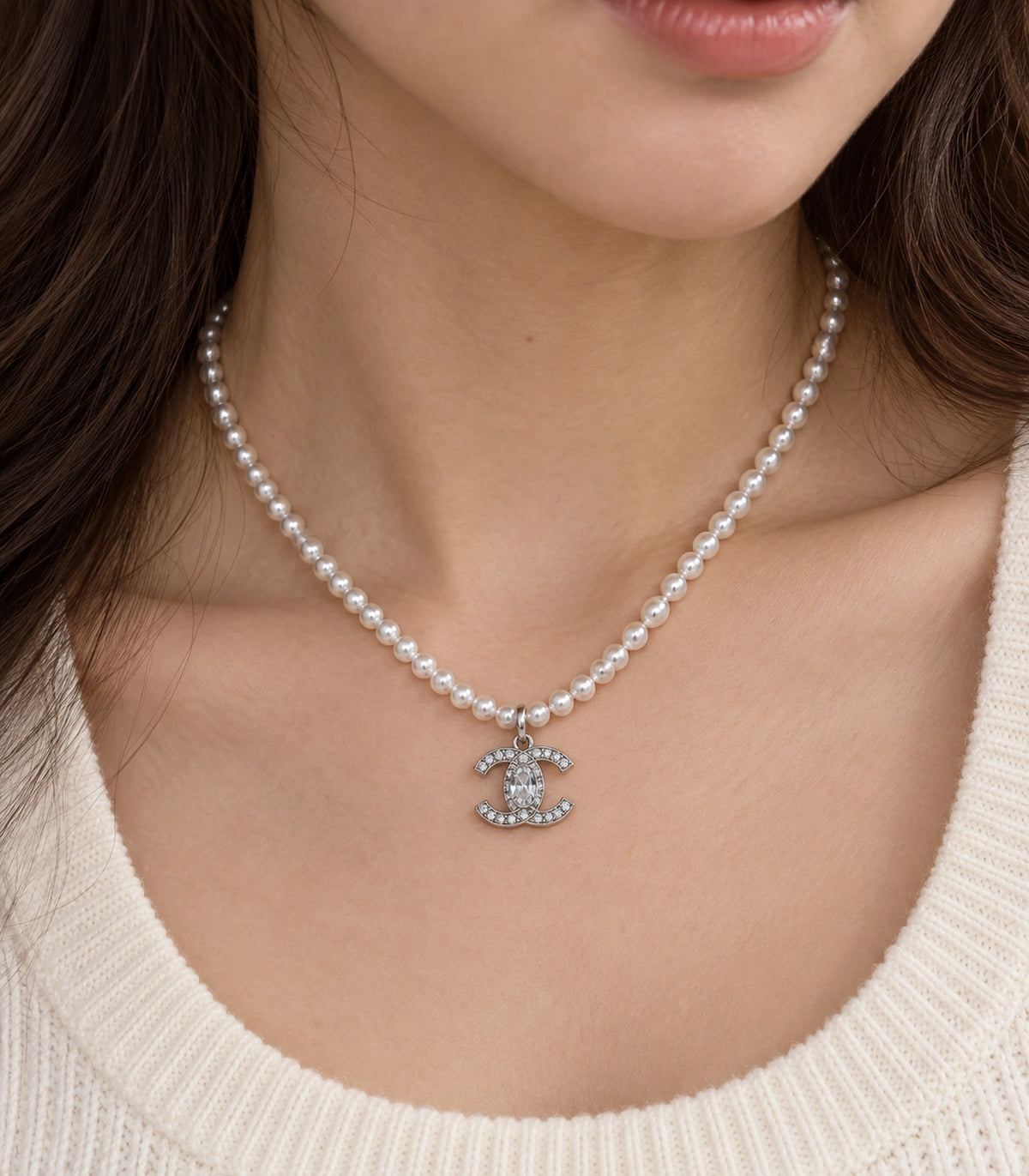 JIMIKI Silver-Tone Double-C Crystal Pearl Necklace in Silver-tone / clear / white, close-up of the pendant and pearl-style strand