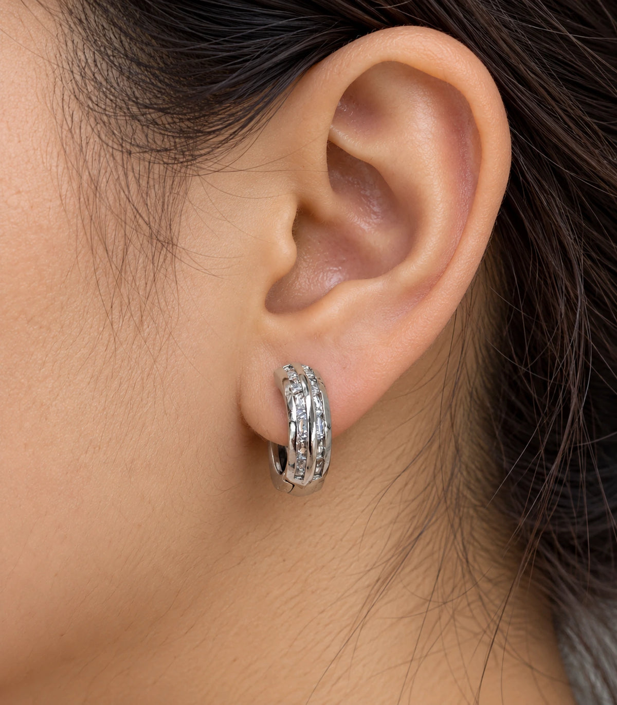 JIMIKI Silver Double Channel Crystal Huggie Hoop Earrings, worn closeup showing front details #color_silver