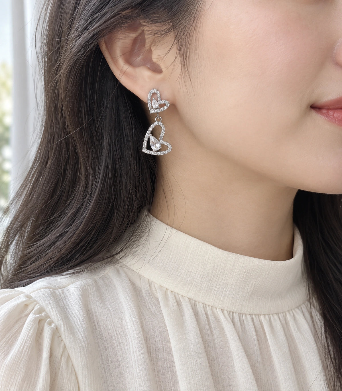 JIMIKI Double Heart Pear Crystal Drop Earrings in Silver Tone, model wearing view #color_silver tone