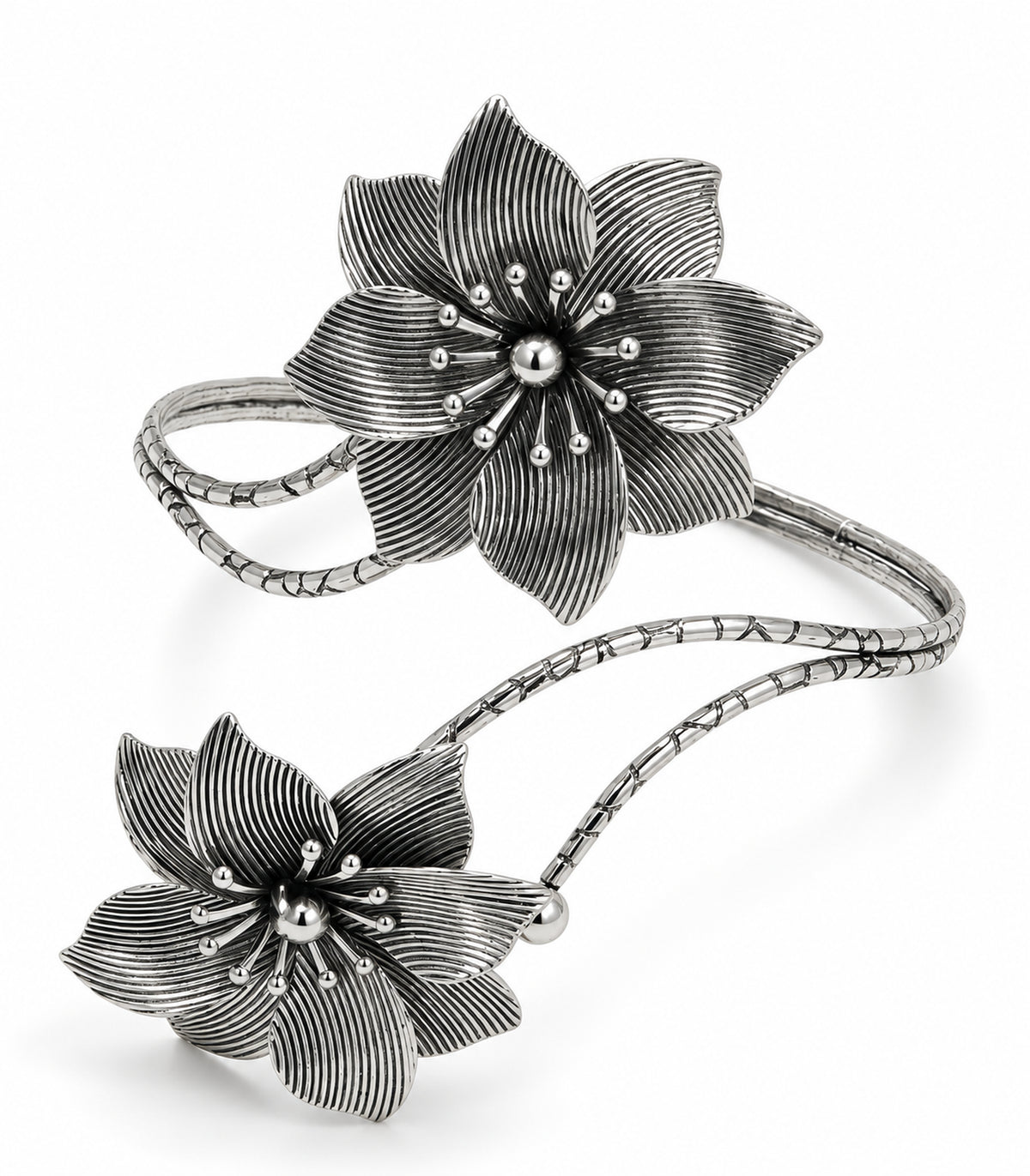 Silver-tone arm cuff with two layered ribbed flowers and segmented double branches on white