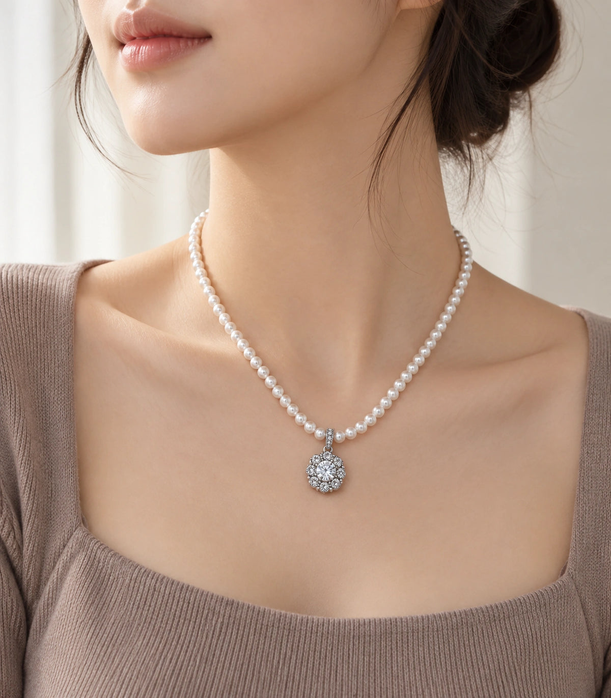 JIMIKI Silver-Tone Floral Cluster Crystal Pearl Necklace in Silver-tone / clear / white, styled on a model in an editorial setting