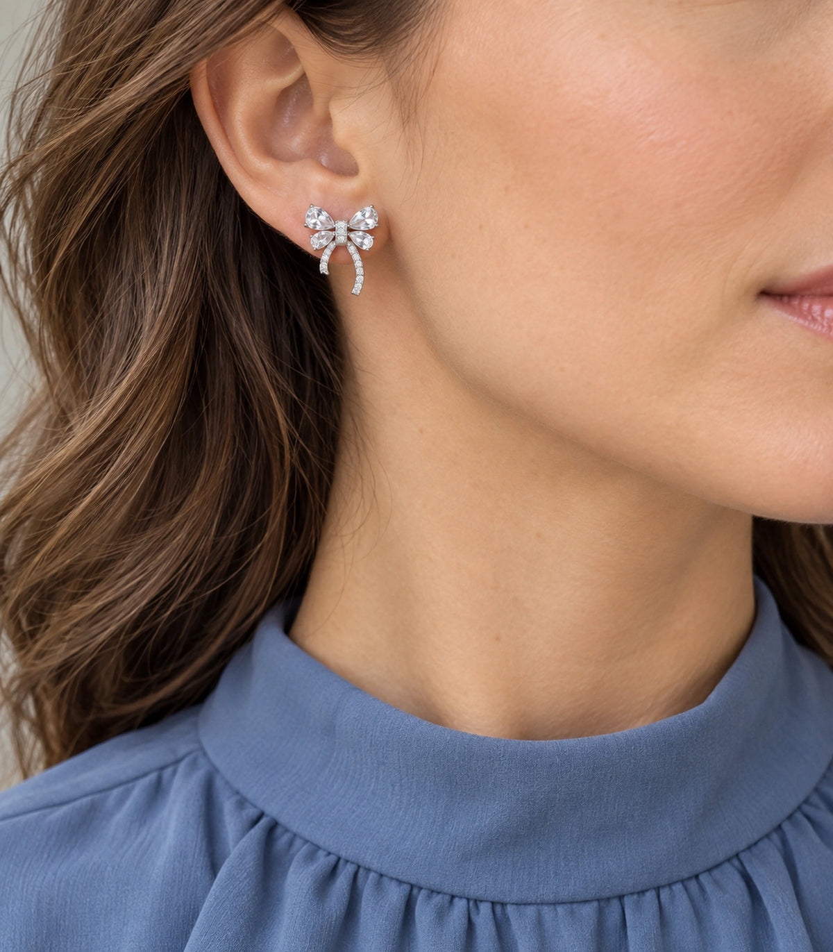 JIMIKI Four Pear Crystal Bow Stud Earring Pair in Silver Tone, model wearing view #color_silver tone