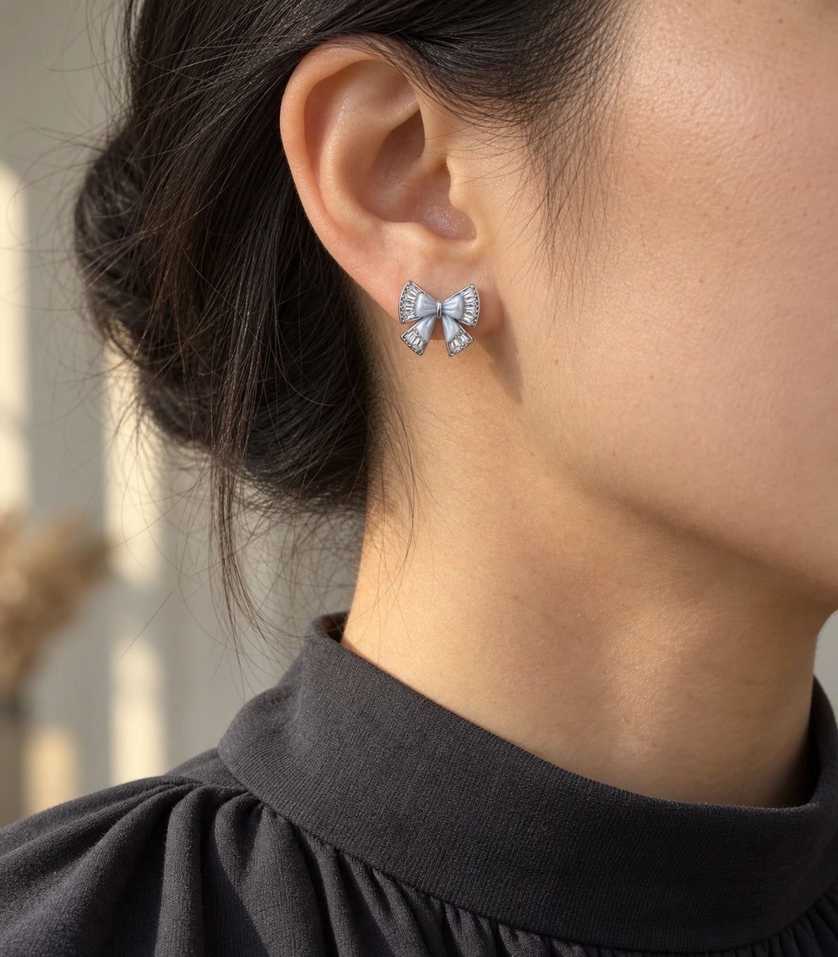 JIMIKI Silver Tone Grey Bow Clear Crystal Stud Earring Pair in Silver tone, editorial model view