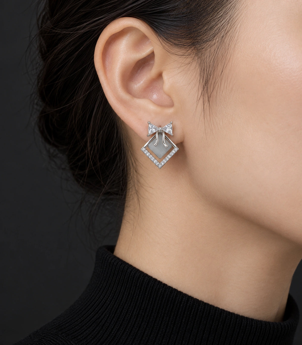 JIMIKI Silver Tone Grey Diamond-Shaped Bow Crystal Stud Earring Pair in Silver tone, editorial model view