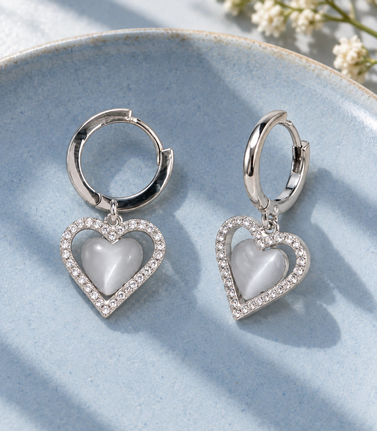 JIMIKI Heart Crystal Frame Drop Hoop Earring Pair in Silver-tone / Grey, editorial flat lay #color_silver-tone / grey