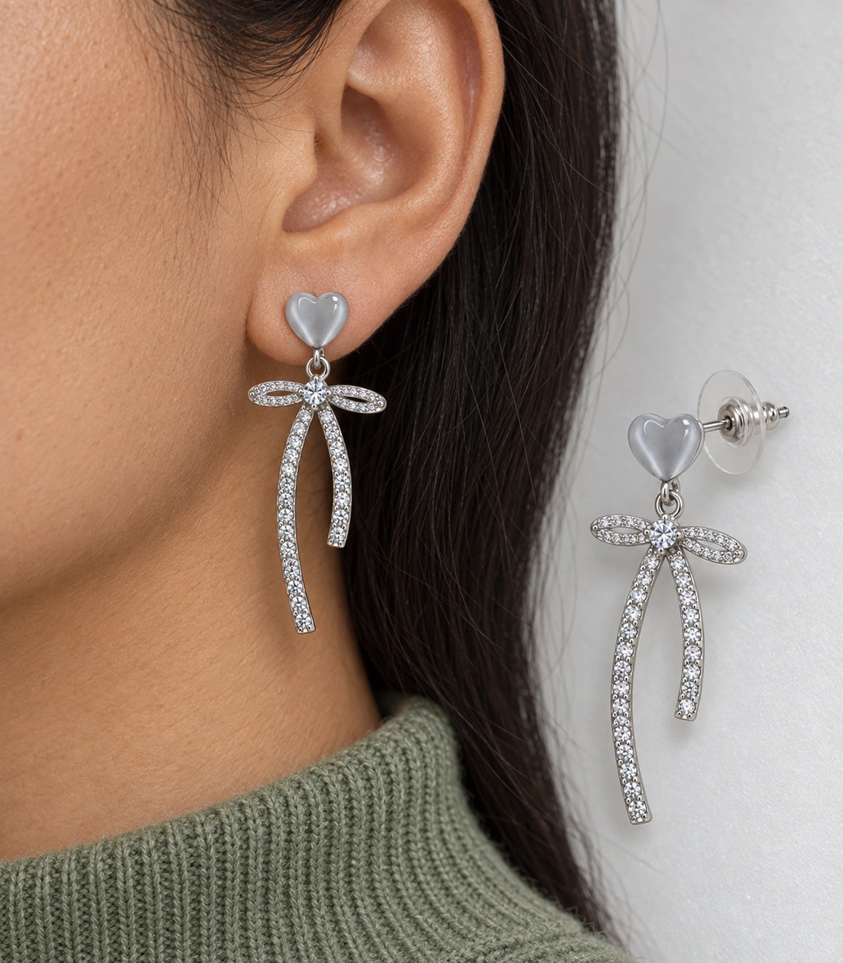 JIMIKI Heart Crystal Ribbon Bow Drop Earring Pair in Silver-tone / Grey, close-up detail #color_silver-tone / grey