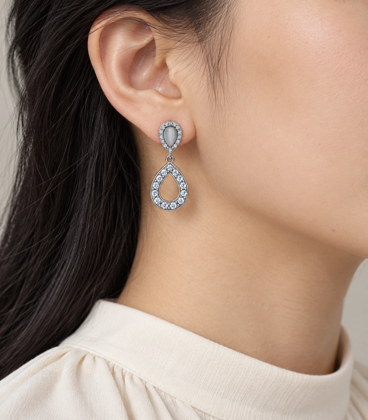 JIMIKI Silver-Tone Grey Teardrop Crystal Halo Drop Earring Pair in Silver Tone, model wearing view