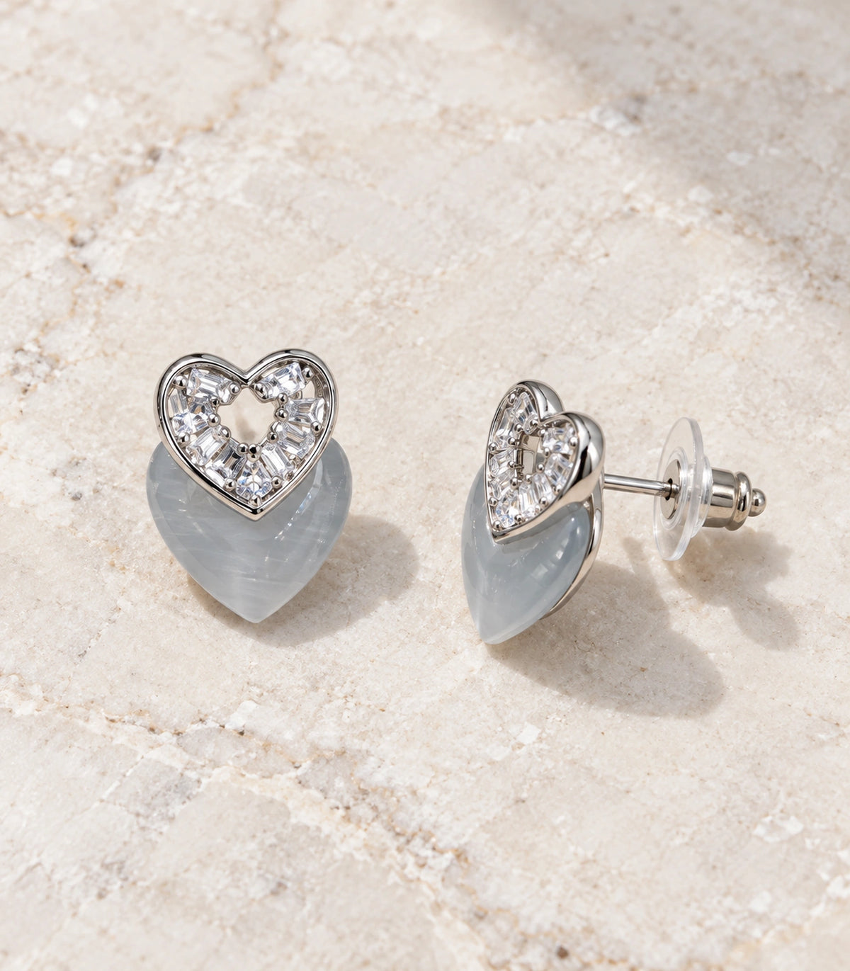 JIMIKI Silver-Tone Layered Crystal Grey Heart Stud Earring Pair in Silver Tone, editorial flat lay