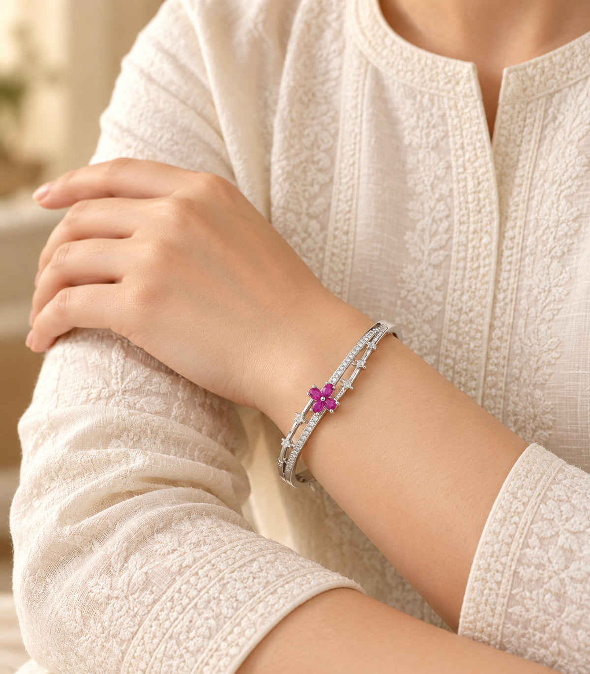 Silver-tone magenta flower and clear bar bangle — editorial model view; one bangle