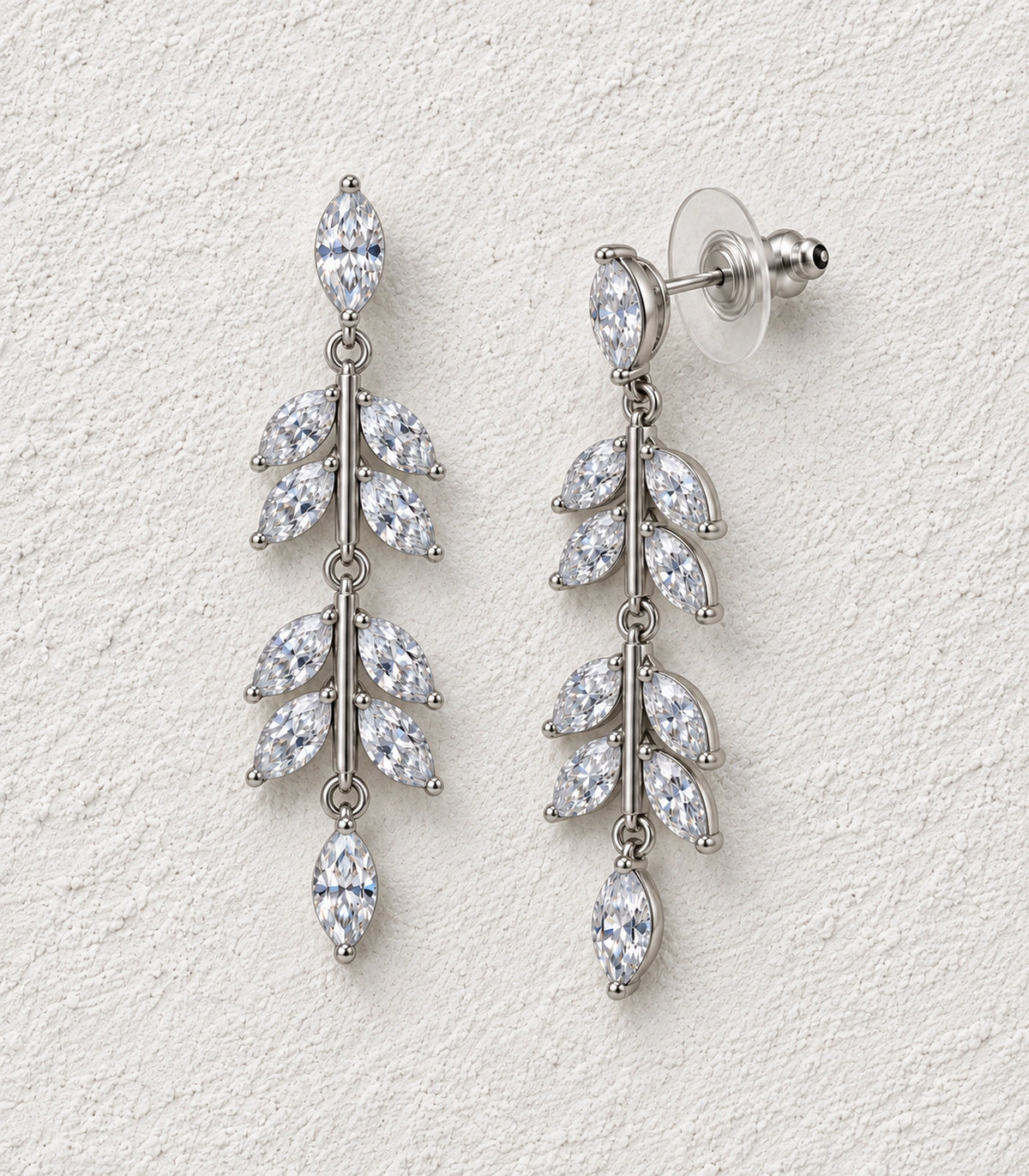 JIMIKI Marquise Crystal Leaf Drop Earring Pair in Silver tone, editorial flat lay #color_silver tone