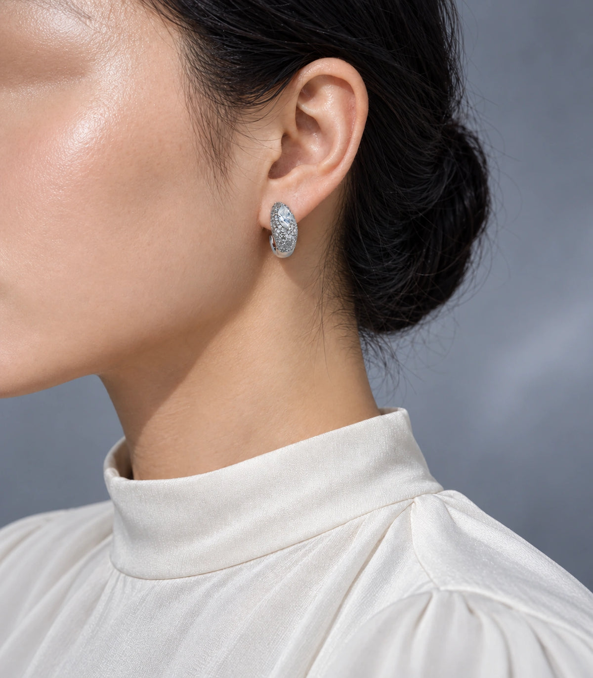 JIMIKI marquise pave open hoop earring pair in silver tone in an editorial model view #color_silver tone