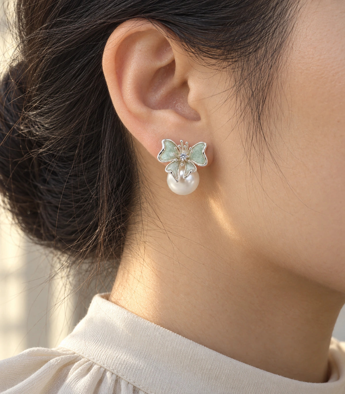 JIMIKI Butterfly Pearl Stud Earring Pair in Silver Tone / Mint, editorial model view #color_silver tone / mint