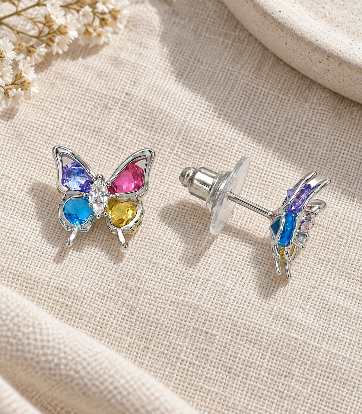 JIMIKI Silver Tone Multicolour Crystal Butterfly Stud Earring Pair in Silver tone, editorial flat lay