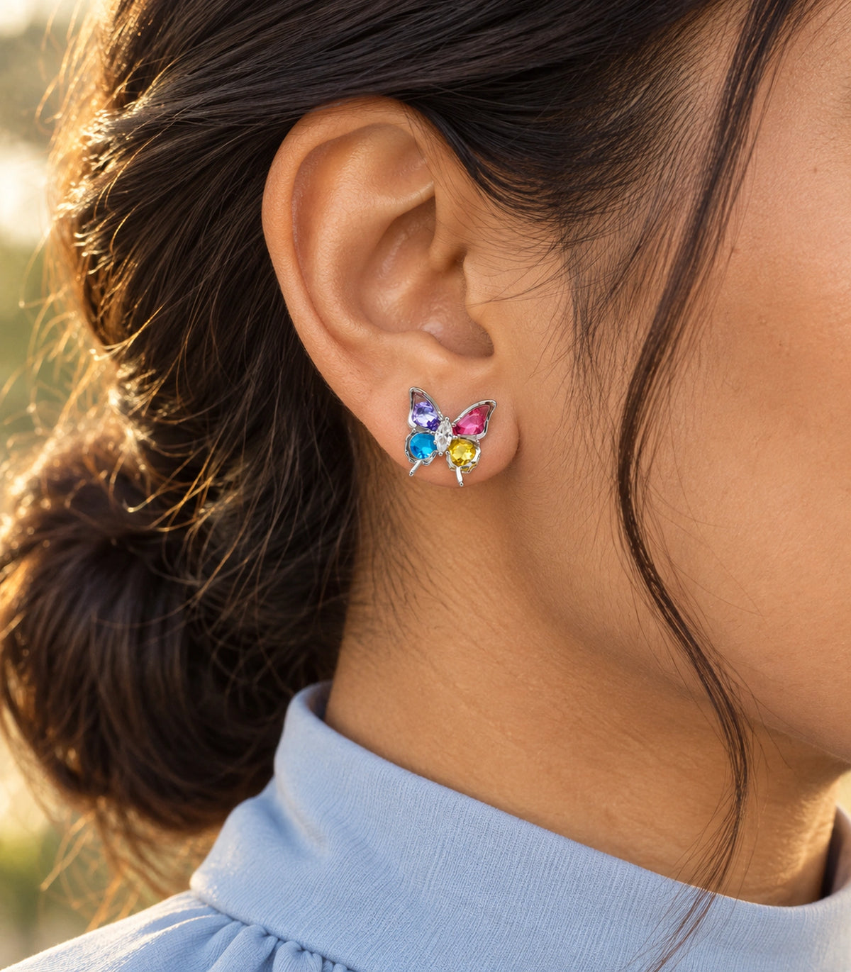 JIMIKI Silver Tone Multicolour Crystal Butterfly Stud Earring Pair in Silver tone, editorial model view