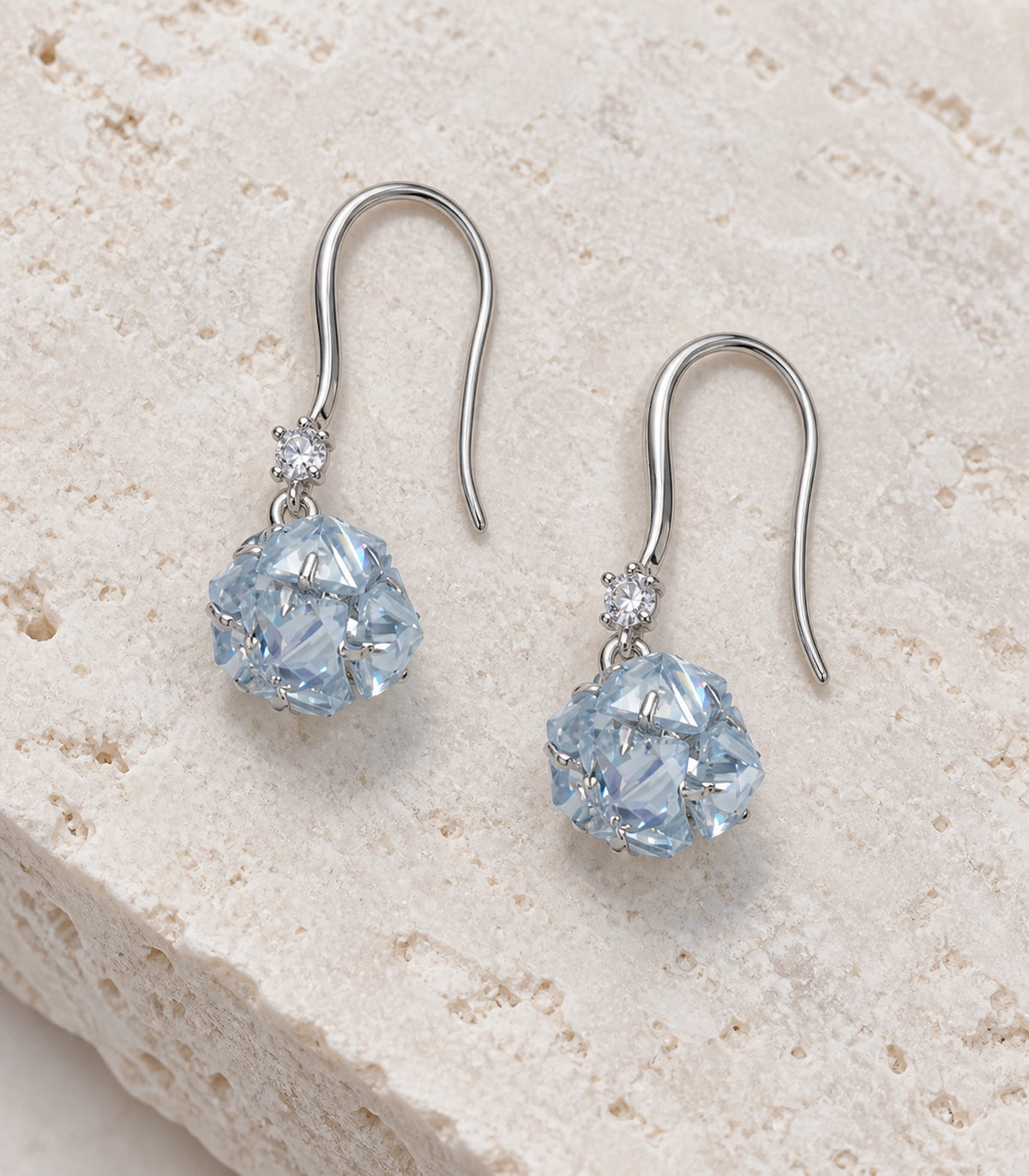JIMIKI Silver Tone Pale Blue Crystal Ball Drop Earring Pair in Silver-tone, editorial flat lay