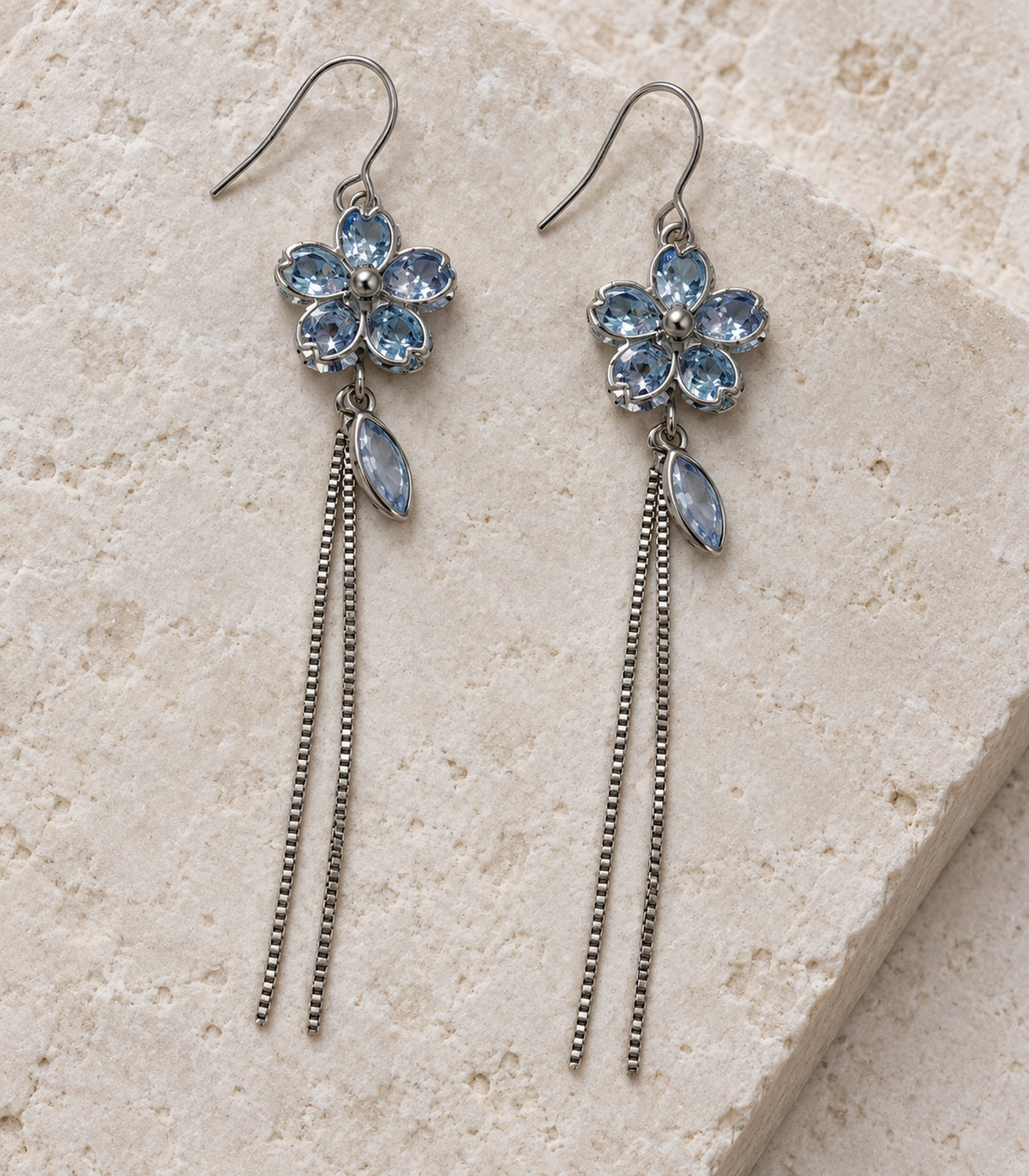 JIMIKI Silver Tone Pale Blue Flower Leaf Chain Earring Pair in Silver-tone, editorial flat lay