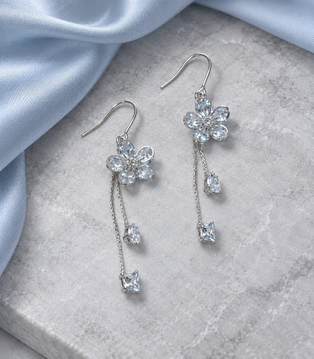 JIMIKI Silver Tone Pale Blue Flower Pear Square Chain Earring Pair in Silver-tone, editorial flat lay