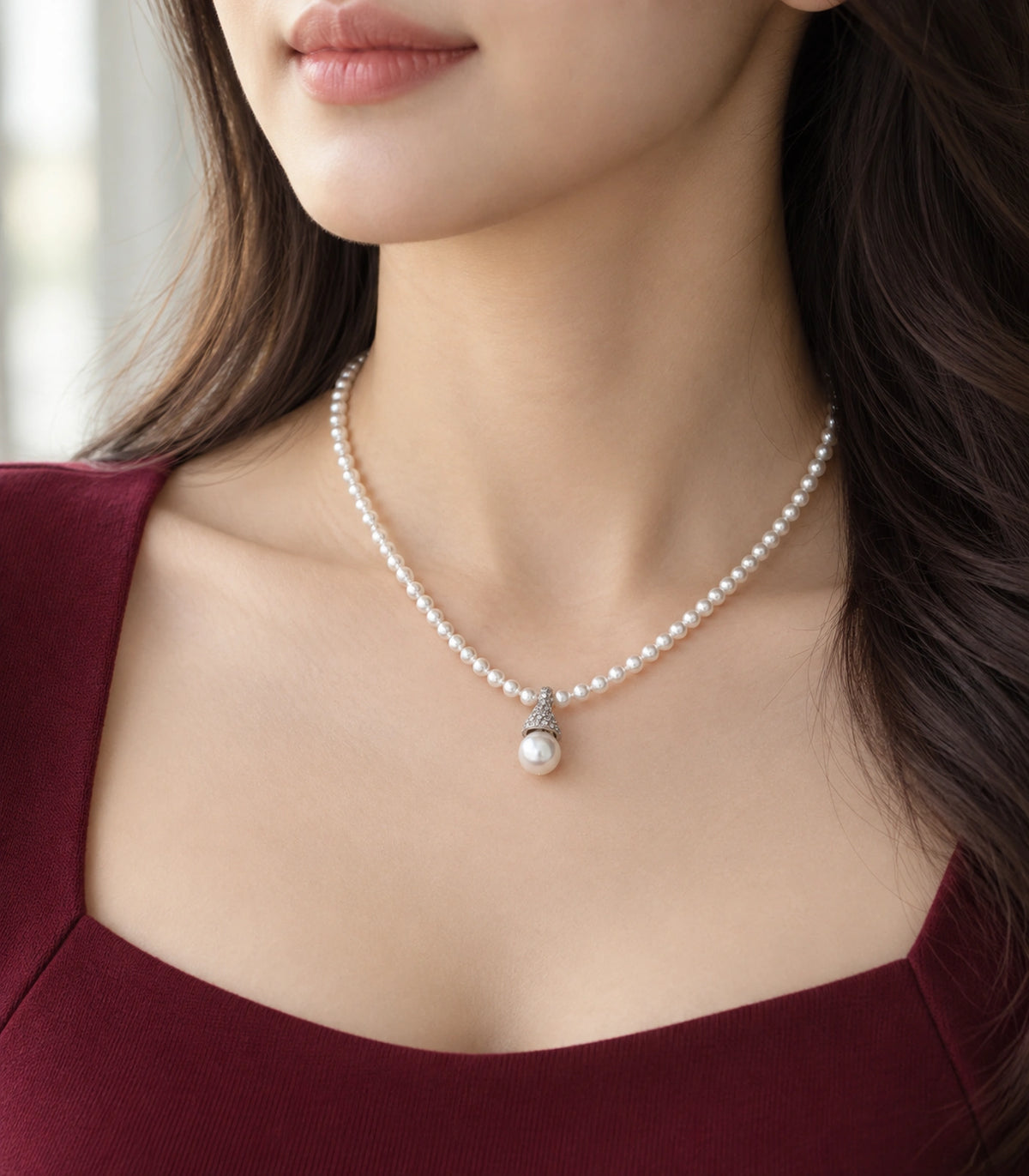 JIMIKI Silver-Tone Pavé Cap Pearl Drop Necklace in Silver-tone / clear / white, styled on a model in an editorial setting