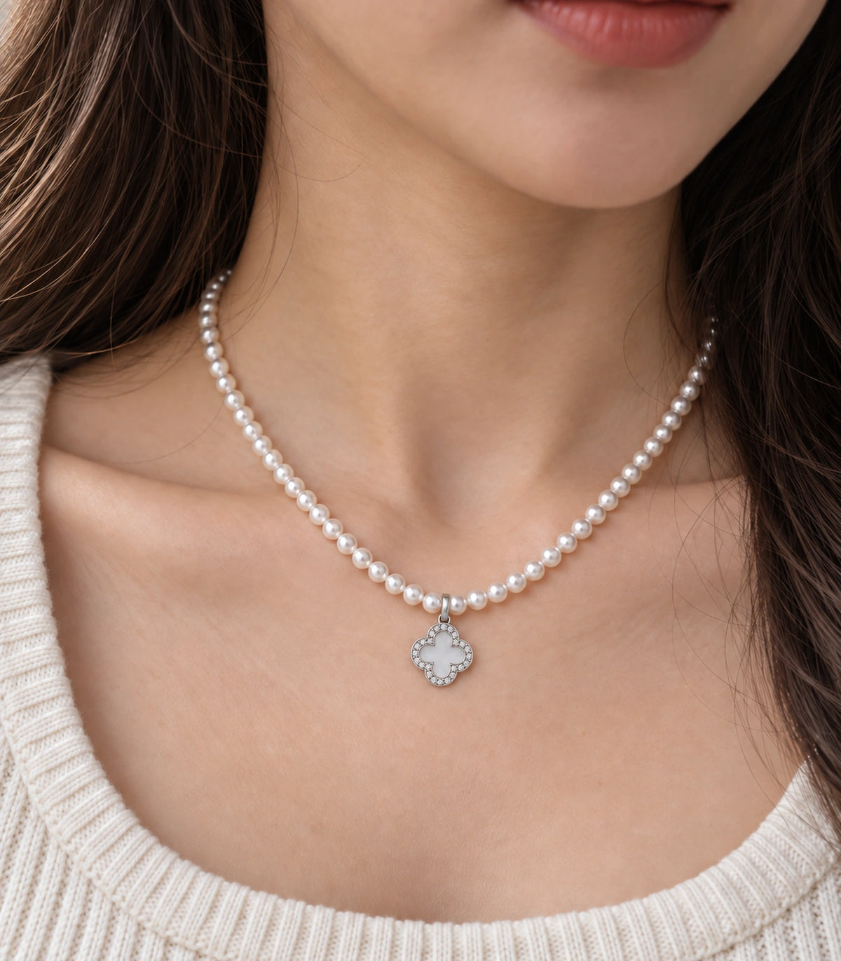 JIMIKI Silver-Tone Pavé Clover Pearl Necklace in Silver-tone / clear / white, close-up of the pendant and pearl-style strand