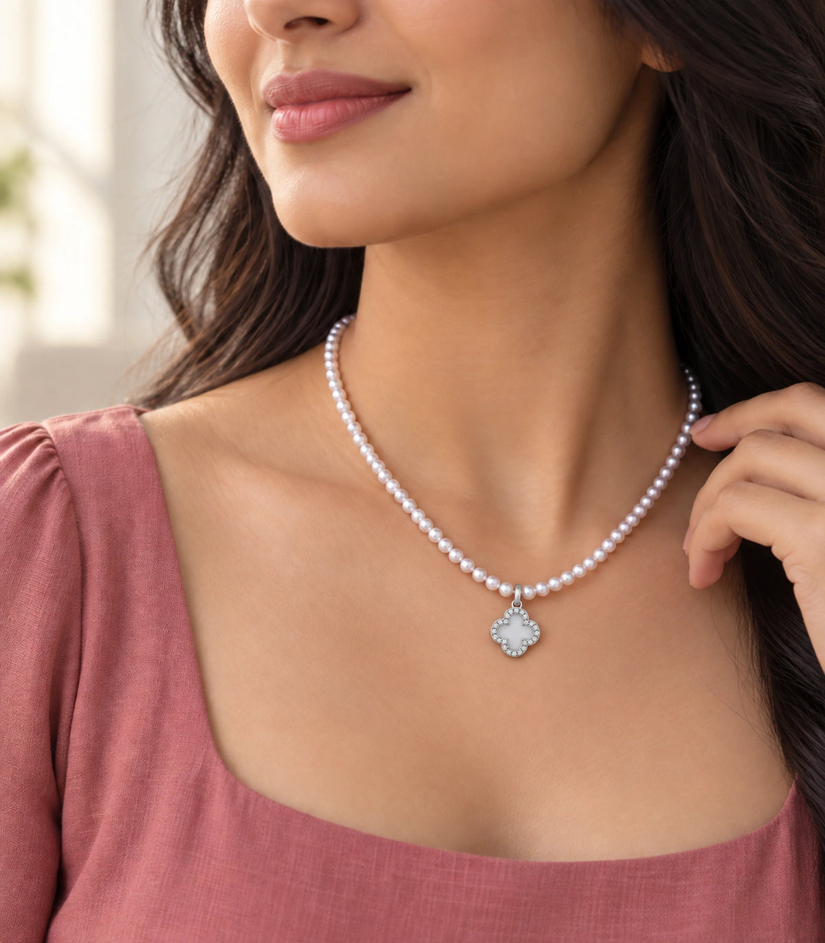 JIMIKI Silver-Tone Pavé Clover Pearl Necklace in Silver-tone / clear / white, styled on a model in an editorial setting