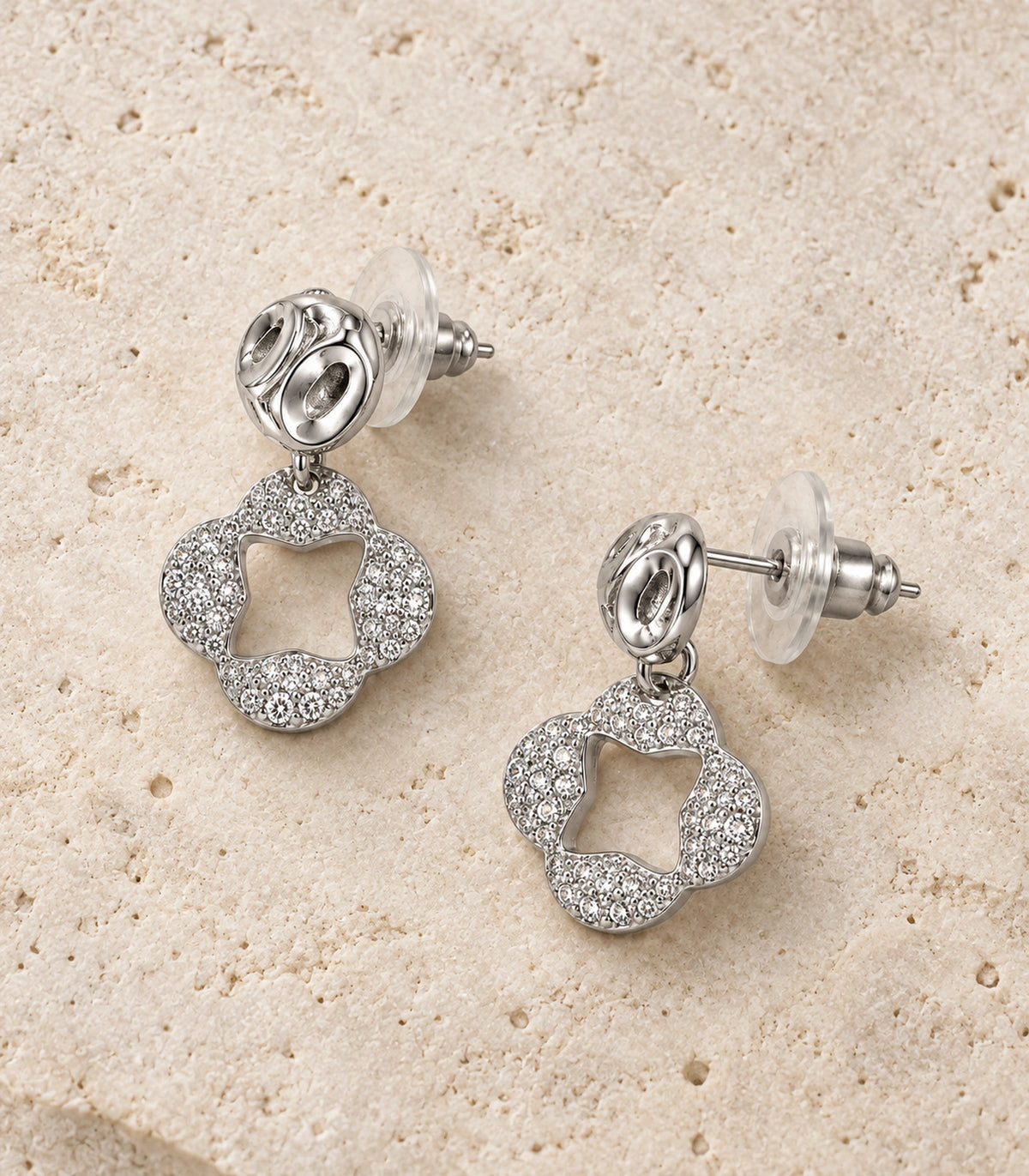 JIMIKI Silver Tone Pave Open Flower Sculpted Stud Drop Earring Pair in Silver tone / clear, editorial flat lay