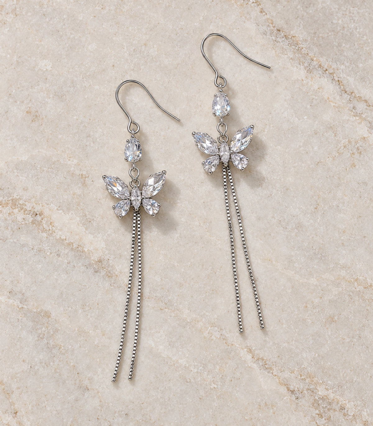 JIMIKI Silver Tone Pear Butterfly Twin Chain Earring Pair in Silver-tone, editorial flat lay