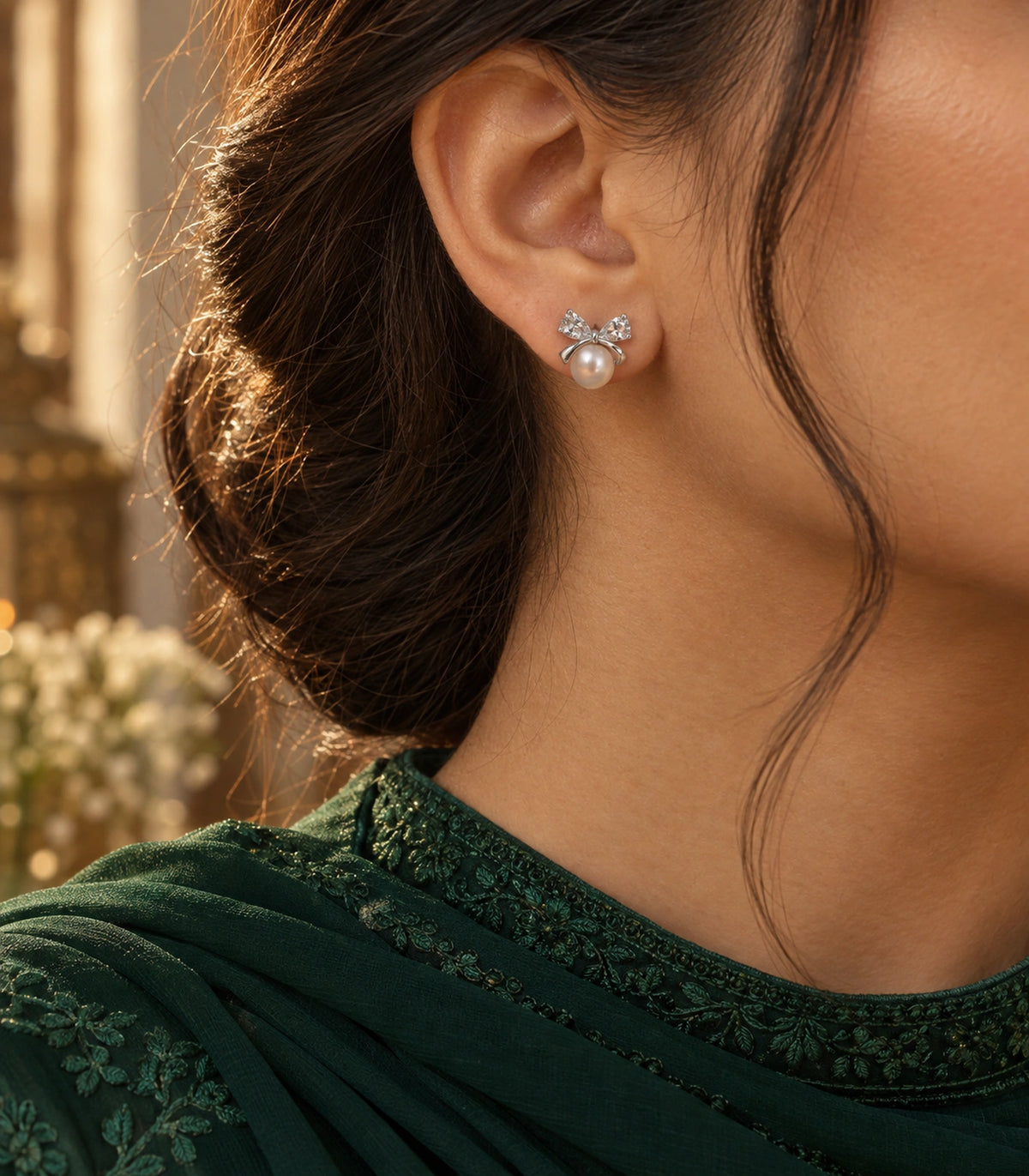 JIMIKI Silver-Tone Pearl Crystal Bow Stud Earrings in Silver / White, editorial model view